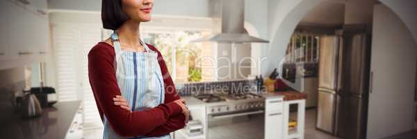 Composite image of waitress standing with arms crossed against white background