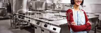 Composite image of smiling waitress standing with arms crossed against white background