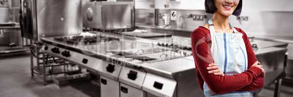 Composite image of smiling waitress standing with arms crossed against white background