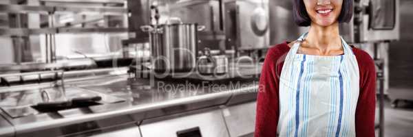 Composite image of smiling waitress in apron standing against white background