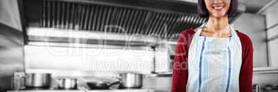 Composite image of smiling waitress in apron standing against white background