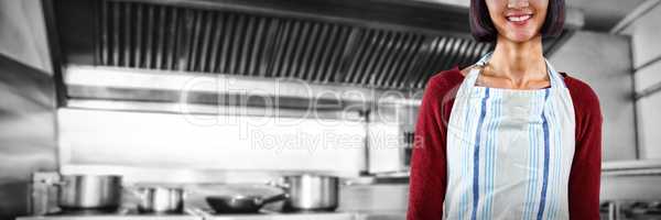 Composite image of smiling waitress in apron standing against white background