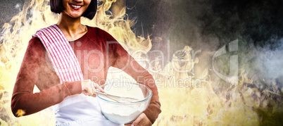 Composite image of smiling female chef mixing flour in bowl with whisk