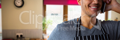 Composite image of male waiter talking on mobile phone