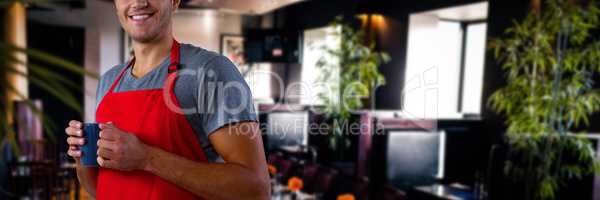 Composite image of male waiter holding coffee mug