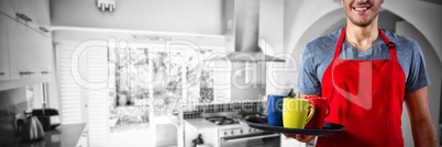 Composite image of male waiter holding tray with coffee mug