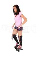 Young woman standing with roller skates