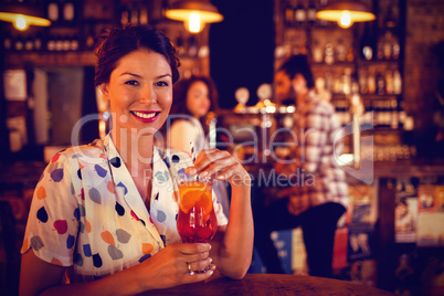 Portrait of young woman having cocktail drink