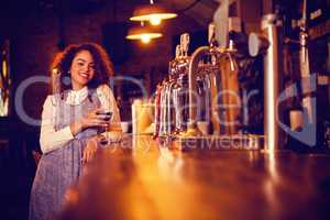 Portrait of young woman having wine at counter