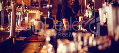 Young waiter using a electronic machine