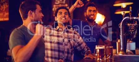 Group of male friends watching football match