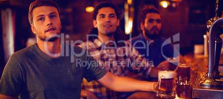 Group of male friends watching football match