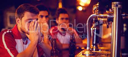 Group of male friends watching football match