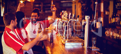 Group of male friends watching football match