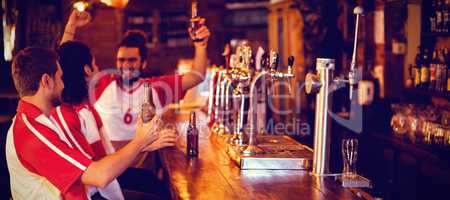 Group of male friends watching football match