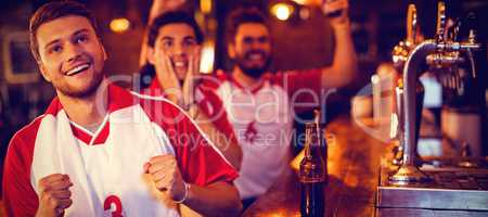 Group of male friends watching football match