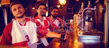 Group of male friends watching football match