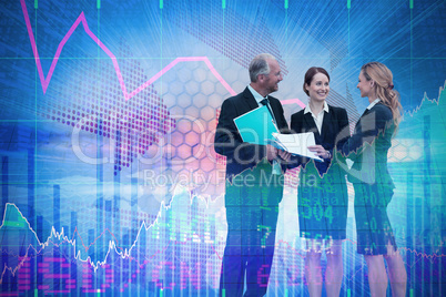 Composite image of businessman discussing with female colleagues standing against white backfround