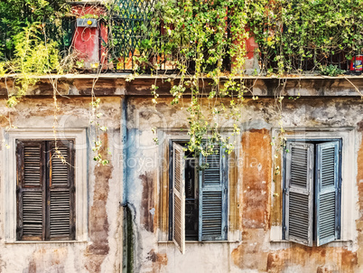 Three ancient windows with closed shutters