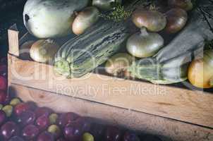 Autumn harvest: zucchini, yellow and red plums, onions