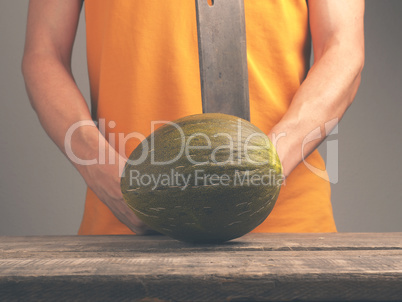 Man with a cleaver and a melon