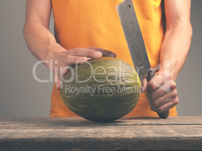 Man with a cleaver and a melon