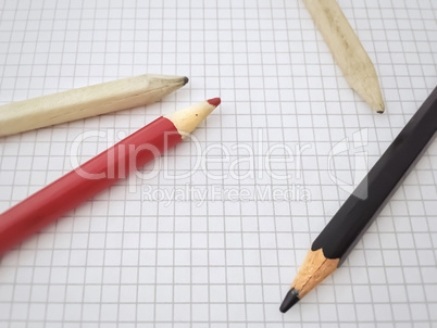 Pencils on a blank sheet of squared paper