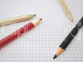 Pencils on a blank sheet of squared paper