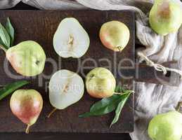 ripe green pears on a brown wooden board