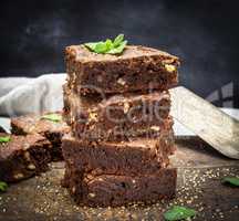 baked square pieces of chocolate brownie pie with walnuts