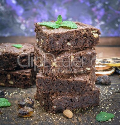 baked square pieces of brownie pie with walnuts