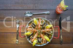 Paella with seafood vegetables and saffron served in the traditi