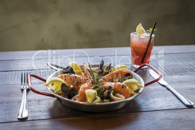 Paella with seafood vegetables and saffron served in the traditi