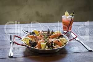 Paella with seafood vegetables and saffron served in the traditi