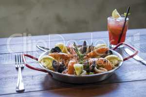 Paella with seafood vegetables and saffron served in the traditi