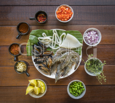 Overhead shot of Raw seafood on plate, healthy food, prawn, clam