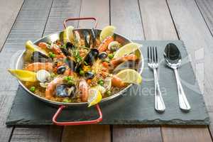 Paella with seafood vegetables and saffron served in the traditi