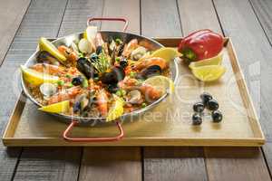 Paella with seafood vegetables and saffron served in the traditi