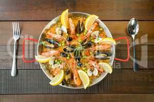 Paella with seafood vegetables and saffron served in the traditi