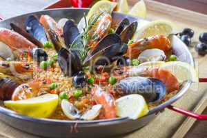 Paella with seafood vegetables and saffron served in the traditi