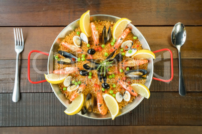 Paella with seafood vegetables and saffron served in the traditi