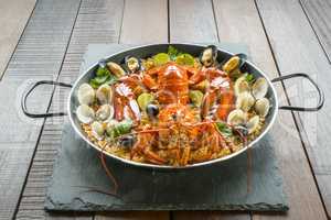 Paella with fresh lobster, clams, mussels and lime