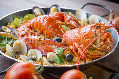Paella with fresh lobster, clams, mussels and squid
