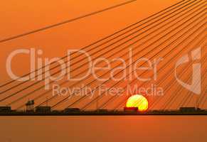 Silhouette of a bridge under setting sun