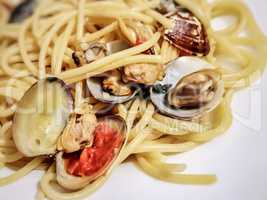 Spaghetti with tiny baby clams in the shell.