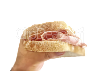 Male hand holding a baked ham sandwich