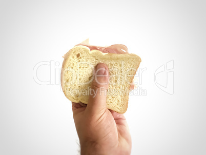 Male hand holding a baked ham sandwich