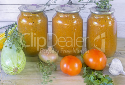 Canned squash caviar with vegetables in glass jars.