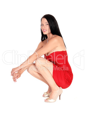 Pretty woman crouching on the floor