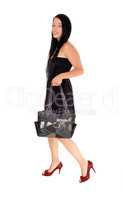 Woman walking in black dress and purse
